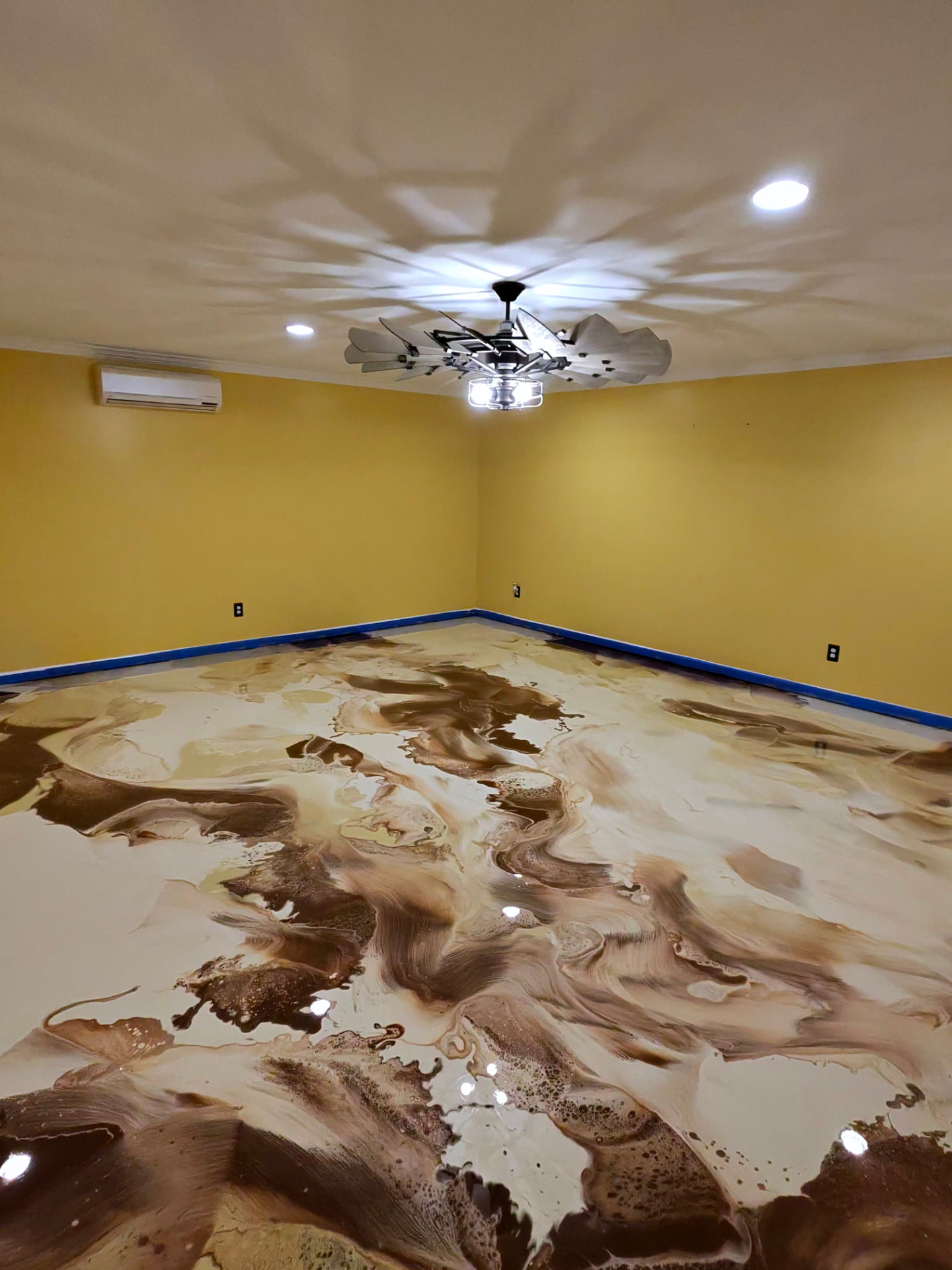 Finished metallic epoxy floor showing marbling and cellular ripples