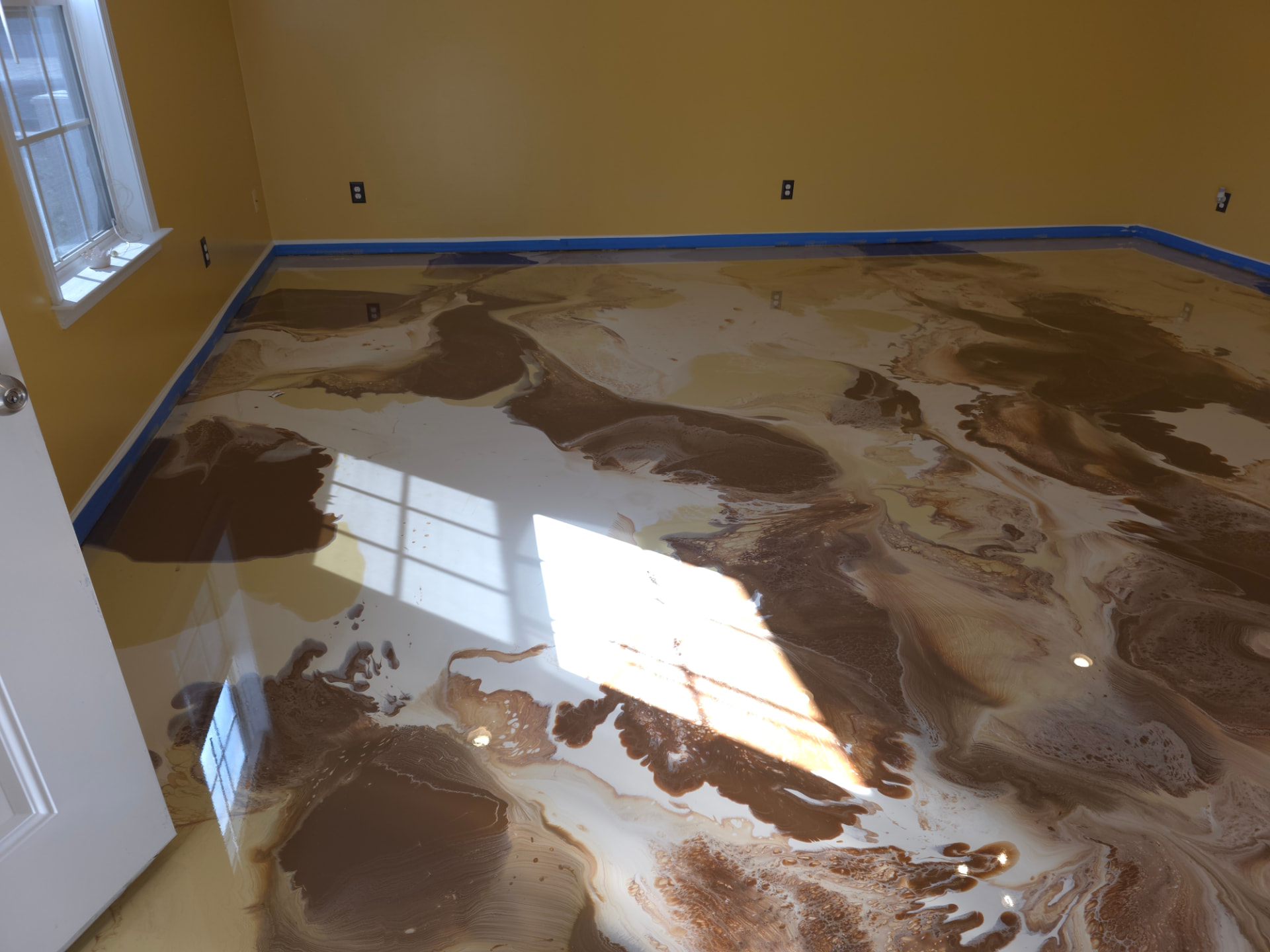 Finished cream and chocolate metallic epoxy floor with mirror gloss