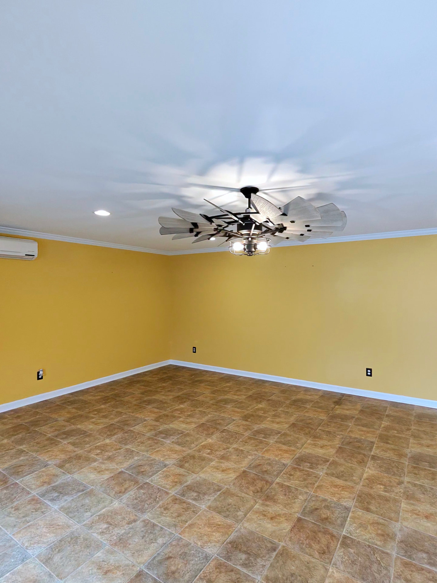 Room with yellow walls and existing tile floor before epoxy install